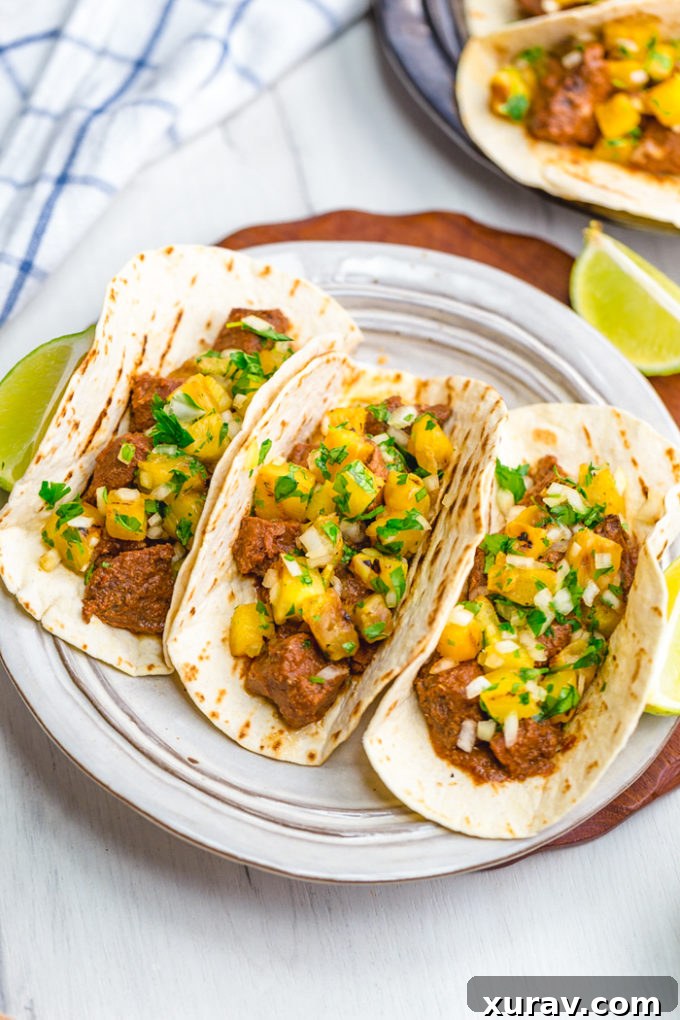 Tacos al Pastor: Delicious Pastor meat and grilled pineapple pico wrapped in a hot grilled tortilla. This tacos al pastor recipe is perfect for a weeknight dinner or a summer night barbecue. It is easier than traditional and uses easy to find ingredients. 