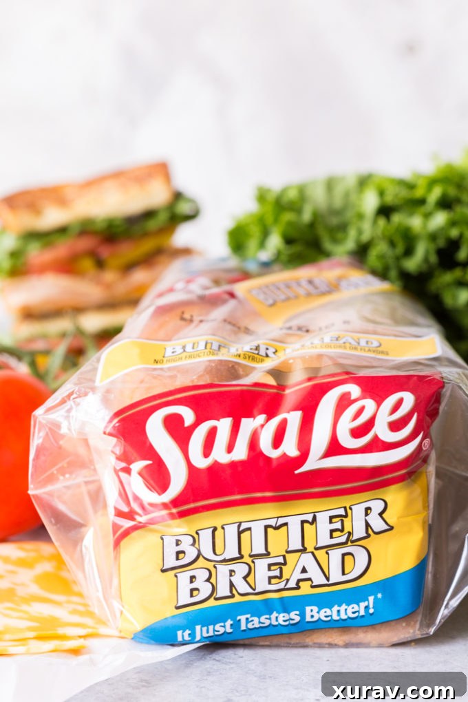 Effortless Chicken Club Stack 4 Close-up of Sara Lee Butter Bread slices, emphasizing its soft texture and rich color, ready for sandwich assembly.
