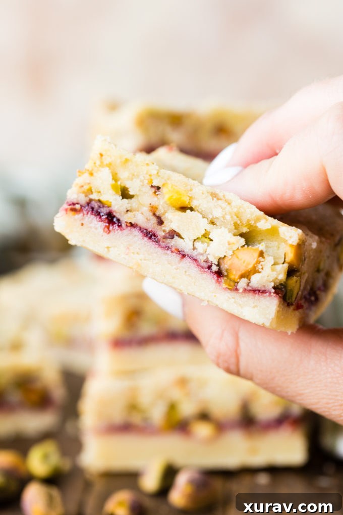 A closer look at the delicious layers of raspberry jam and pistachios on a shortbread base.