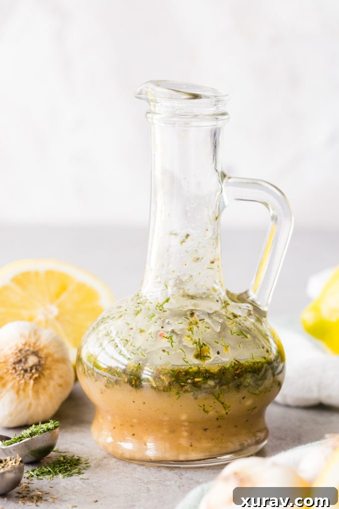 Bottle of Greek Chicken Marinade with lemons, garlic, and herbs around it. 