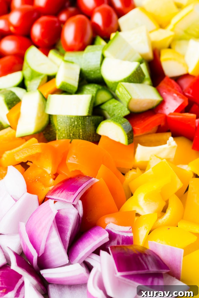 A selection of fresh vegetables, meticulously chopped and ready for roasting.