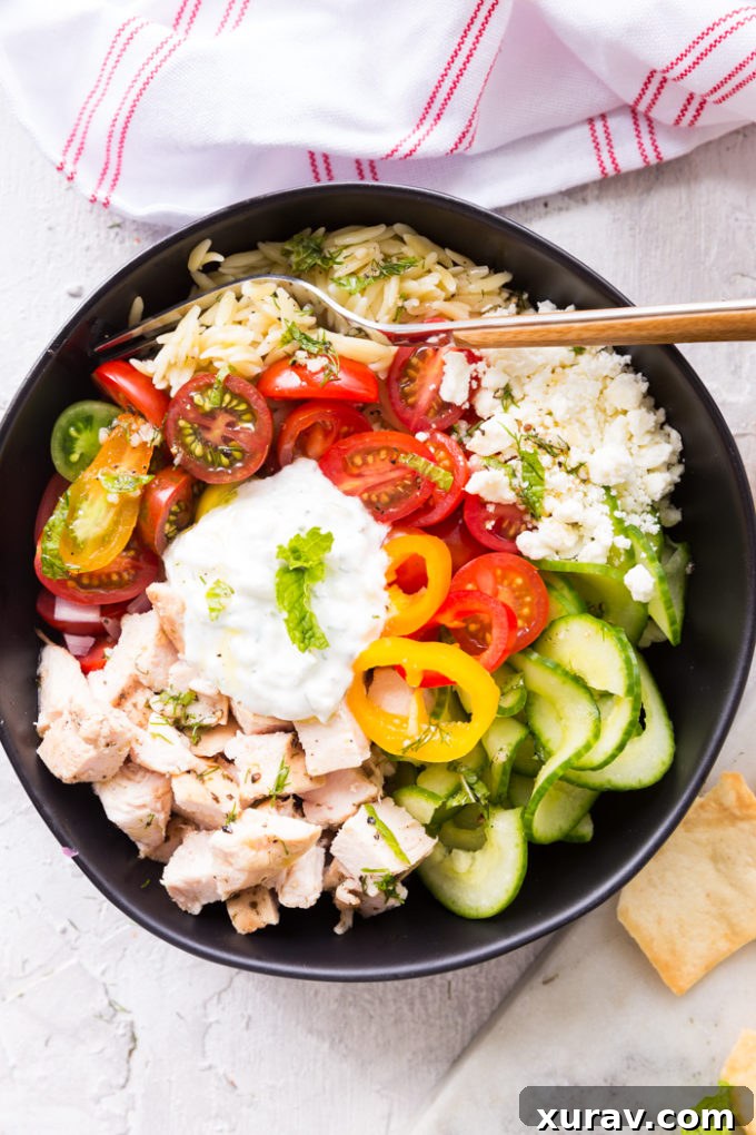 Delicious Greek Chicken Orzo Power Bowl with fresh ingredients