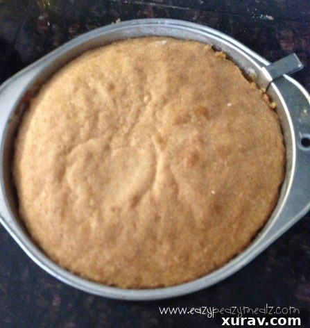 A sliced 8-inch butter cake, showcasing layers of tender cake, strawberries, and cream.