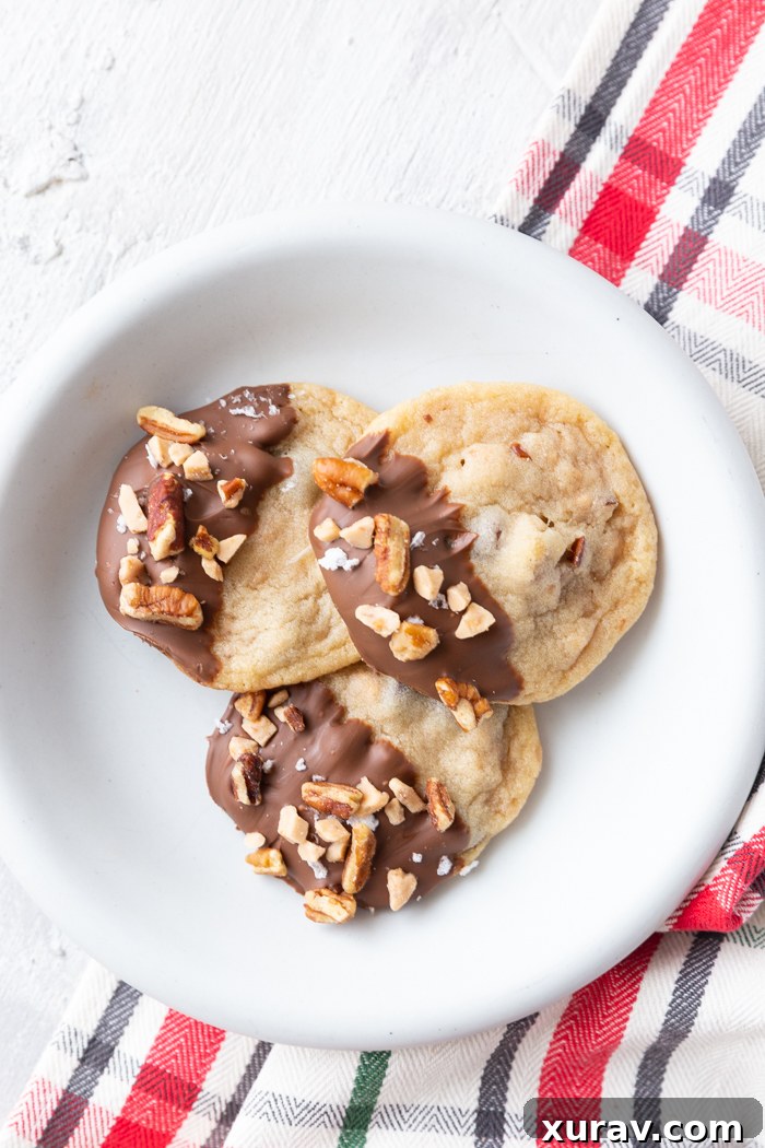 Toffee pecan christmas cookies on a white plate with a red plaid napkin