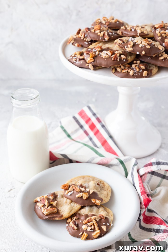 A white cake stand with cookies, as well as a plate of cookies and glass of milk
