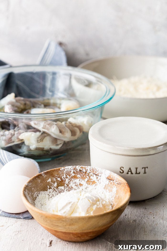 All the ingredients you need for air fryer coconut shrimp laid out on a table