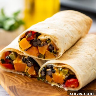 Sweet Potato Black Bean Burritos with a creamy sauce and fresh cilantro