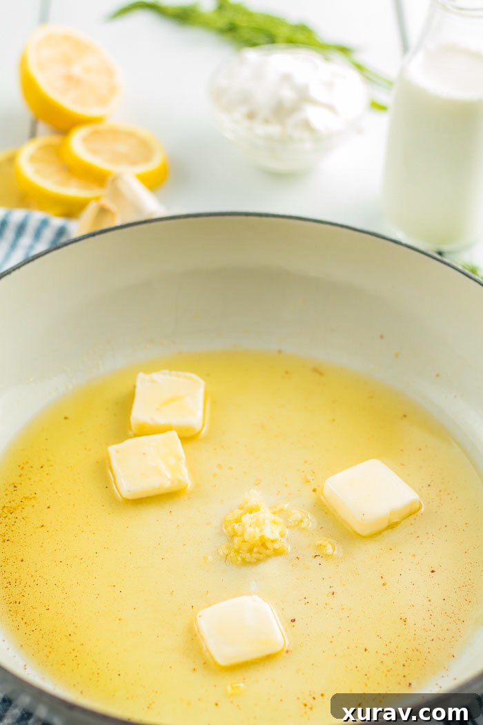 Step one of the salmon recipe is adding butter and garlic to the pan.