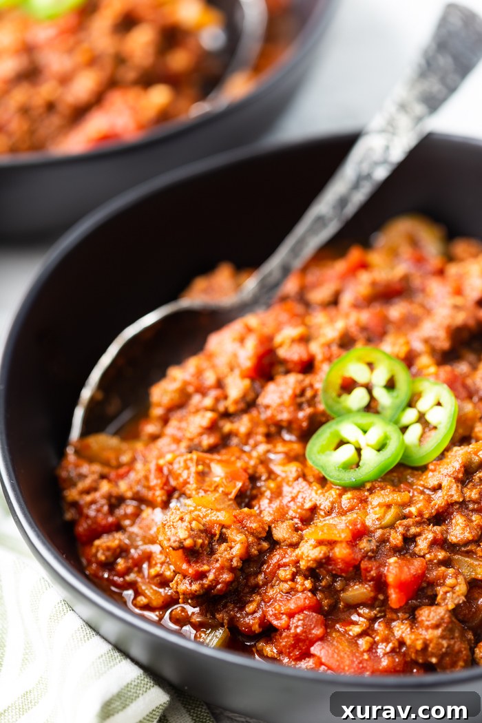 Low carb (beanless) chili, garnished with fresh herbs in a rustic bowl