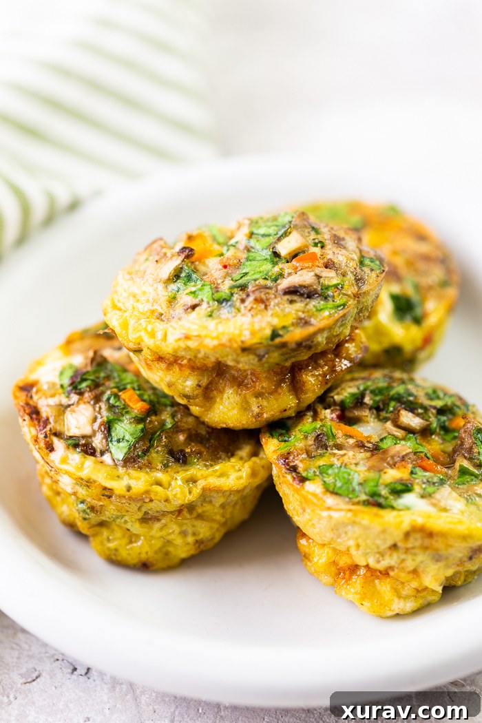 mixed veggies sausage egg cups on a white plate