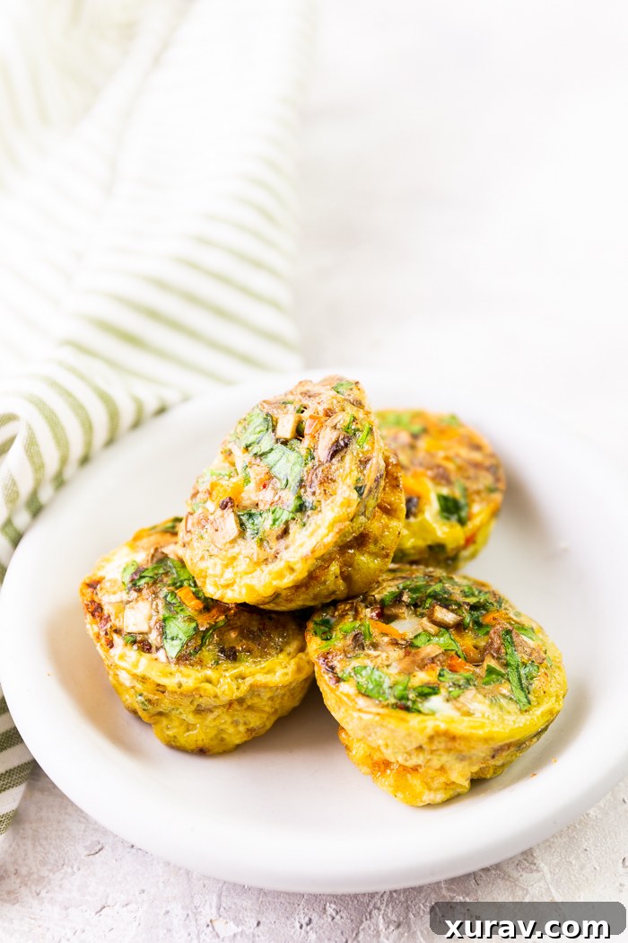 mixed veggies sausage egg cups on a white plate