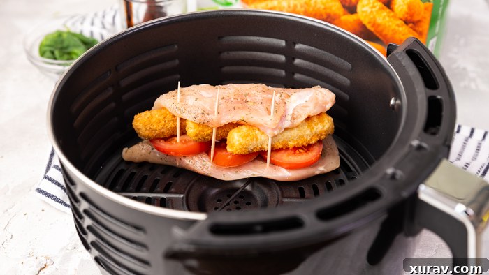 Air fryer cooked caprese chicken, showcasing its golden crispy skin.