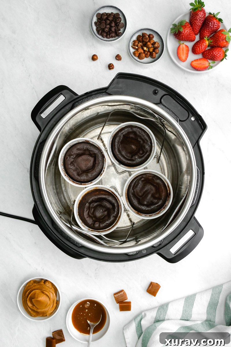 Four individual ramekins filled with lava cake batter, neatly arranged and ready for pressure cooking in the Instant Pot.