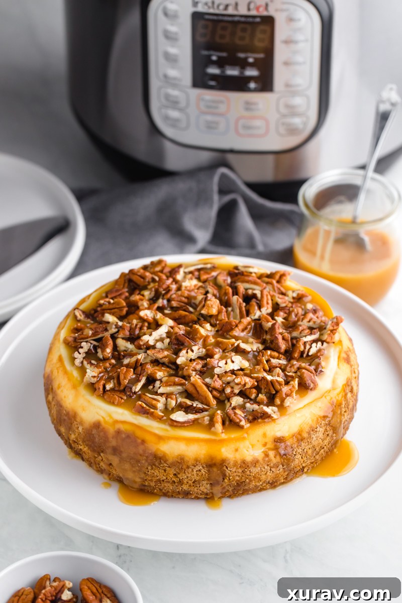 An instant pot cheesecake topped with caramel and pecans