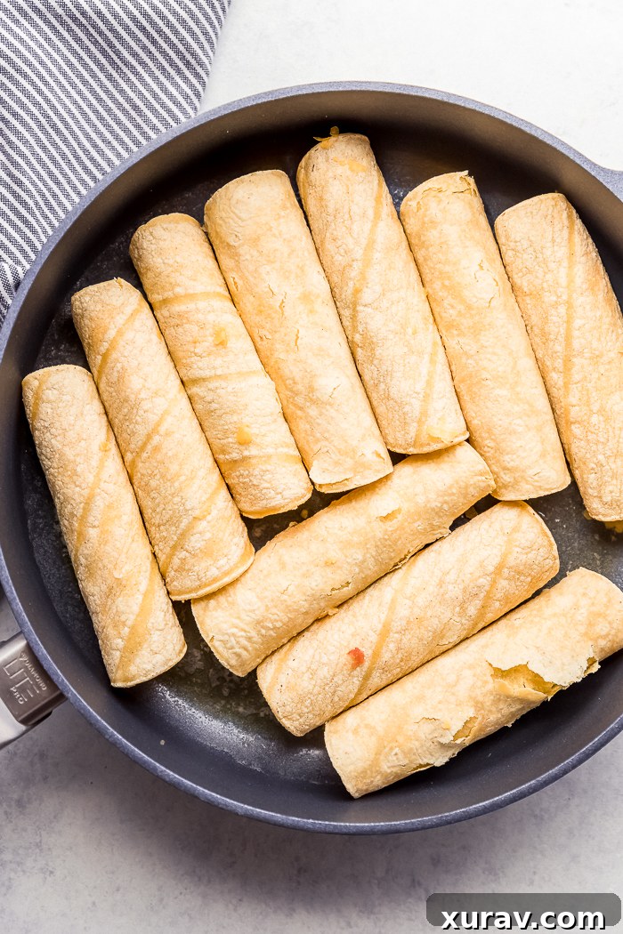 Corn tortilla taquitos in a skillet
