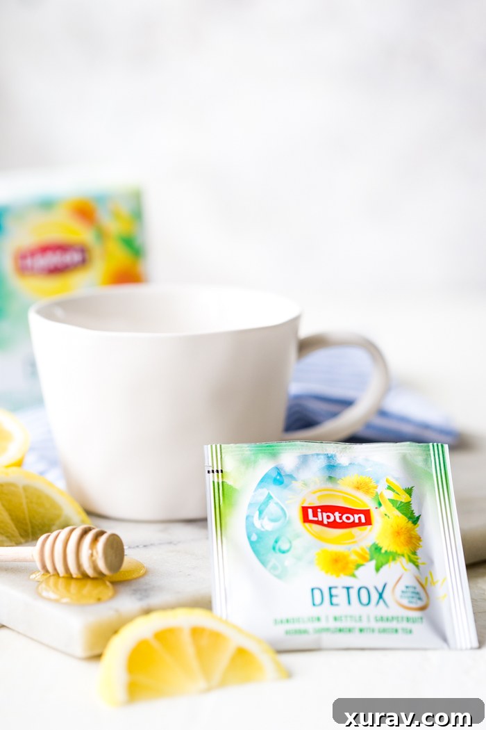 A single serve detox tea with a white mug, lemon slice, and honey