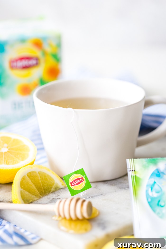 Letting your tea steep in a white mug with lemons