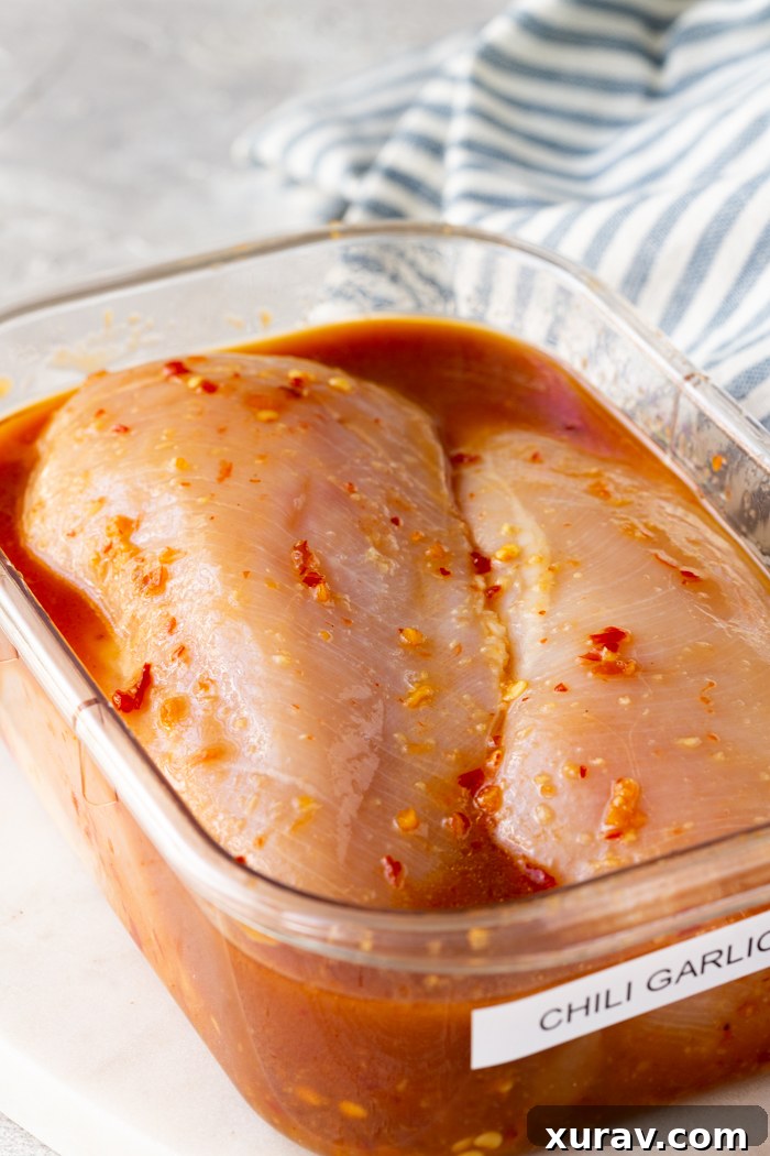 Chili Garlic Marinade in a jar with ingredients around it.