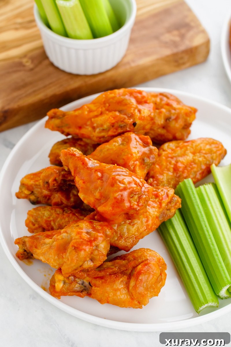 A plate of crispy buffalo wings and celery