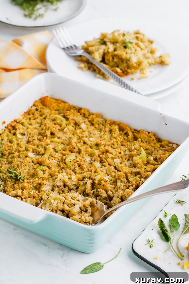 A close-up shot of cornbread dressing baking in a clear glass casserole dish, showing its moist texture and golden-brown top.