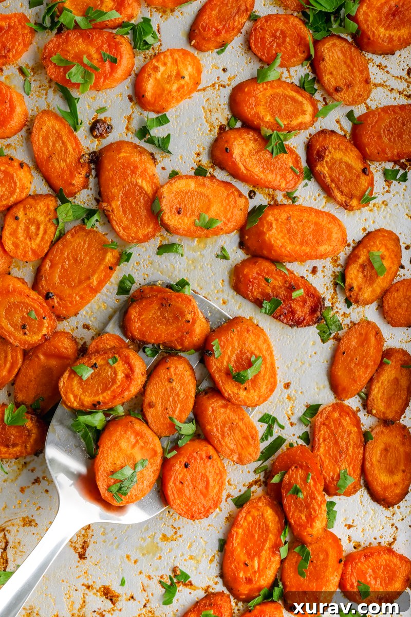 Close-up of golden-brown roasted carrots on a baking sheet