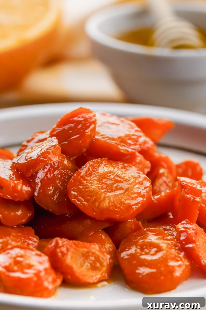 Roasted carrots in a serving dish, garnished with fresh herbs