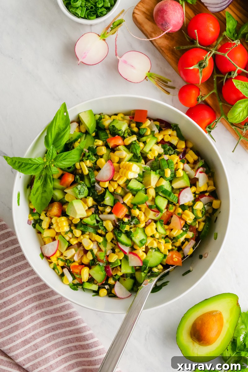 A large bowl of colorful corn salad