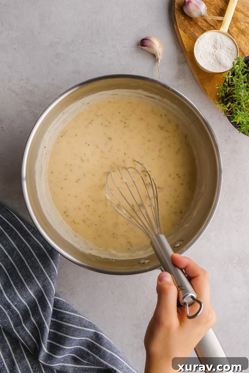 Serving of slow cooker chicken pot pie with a golden biscuit on top.
