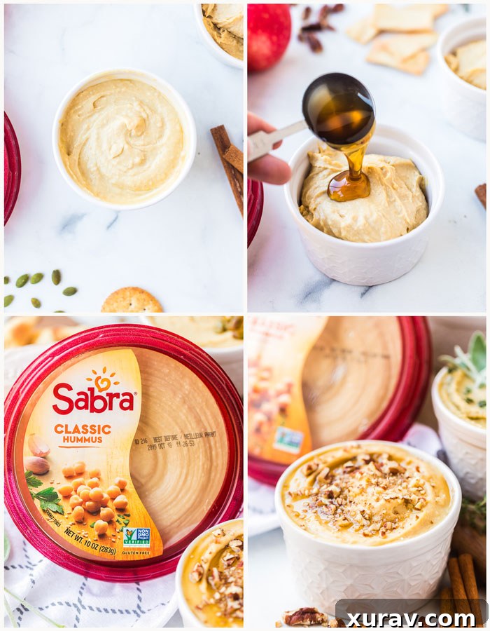 A bowl of classic hummus adorned with a generous topping of savory spiced pumpkin seeds, accompanied by pita bread and baguette slices.