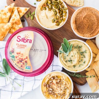 A beautifully presented Sabra Hummus Appetizer Flight with various toppings and dippers.
