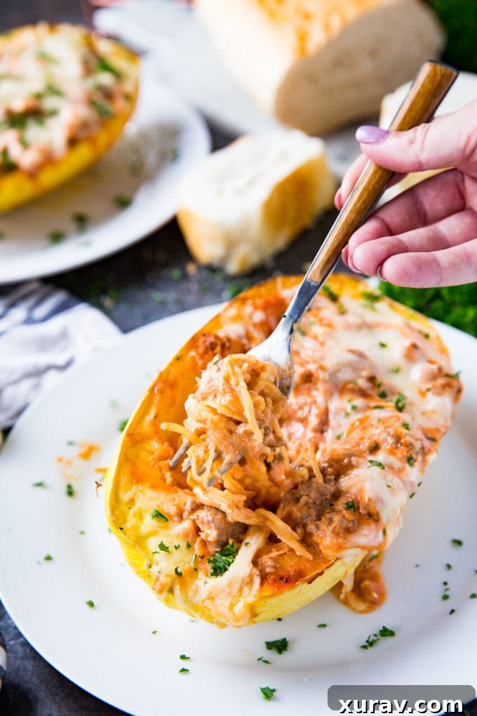 Spaghetti squash lasagna with a vibrant mixture of sausage, cheese, and marinara sauce, garnished with fresh herbs.
