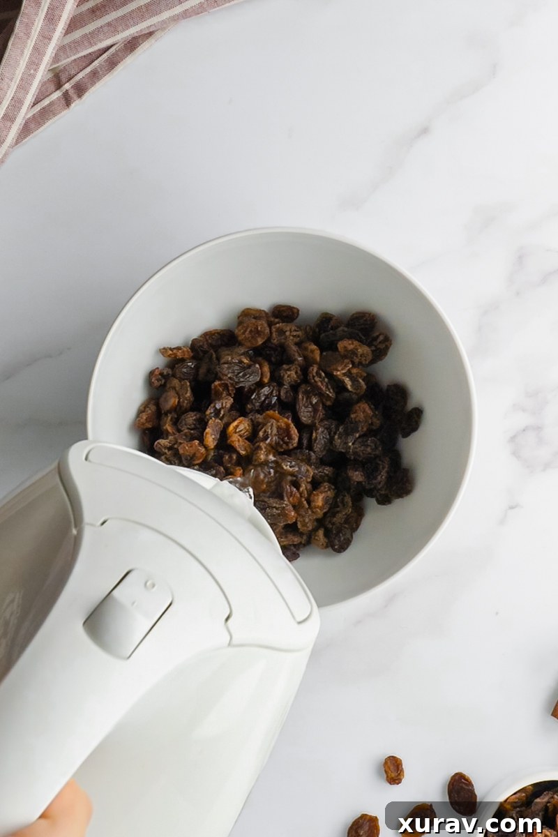A delicious oatmeal raisin cookie with a bite taken out, revealing its chewy interior