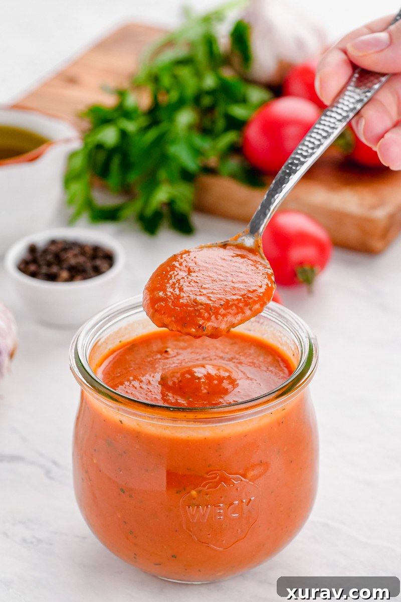 A bowl of fresh keto marinara sauce with basil garnish.