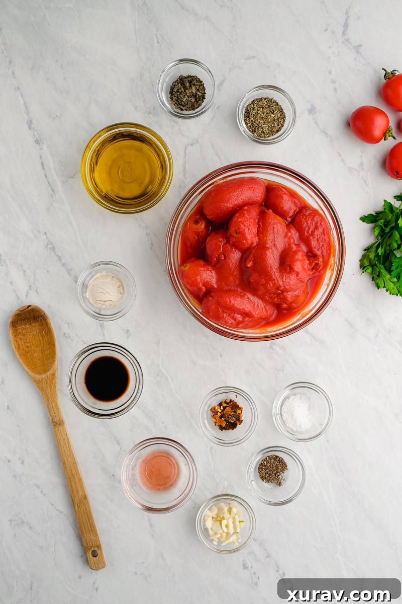 High-quality ingredients for making keto marinara, including San Marzano tomatoes, olive oil, and various spices.