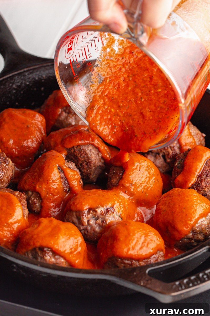 A skillet full of savory meatballs covered in keto marinara sauce.