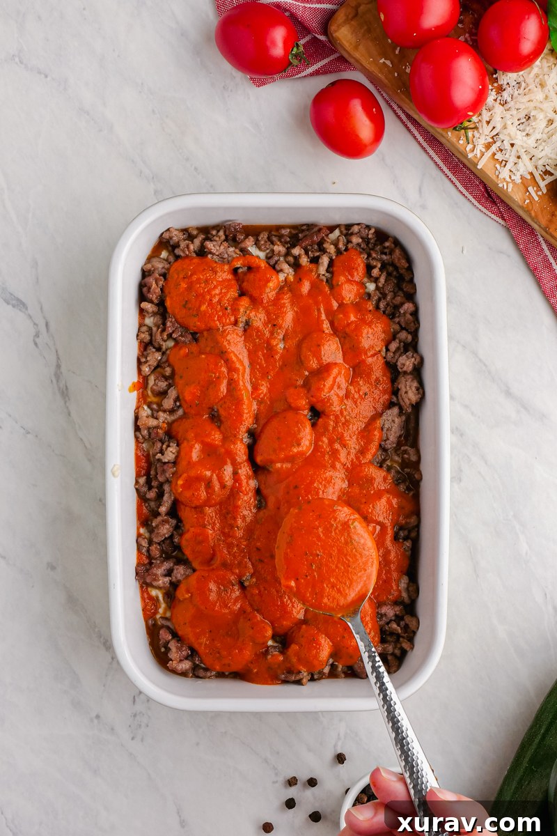 A tray of delicious keto lasagna with layers of meat, cheese, and marinara sauce.