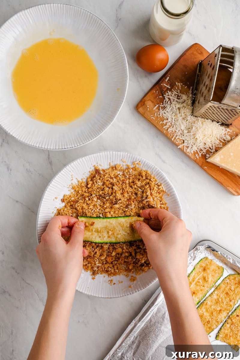 A close-up of thinly sliced zucchini strips being prepared