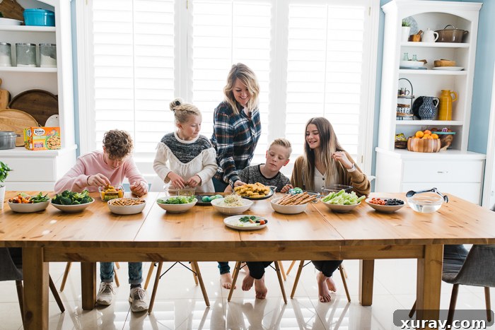 A close-up of a colorful bento box with Yummy Dino Buddies and fresh produce.