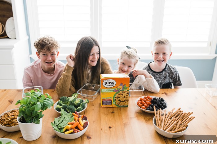 A bento box filled with Yummy Dino Buddies, sliced bell peppers, and other snacks.