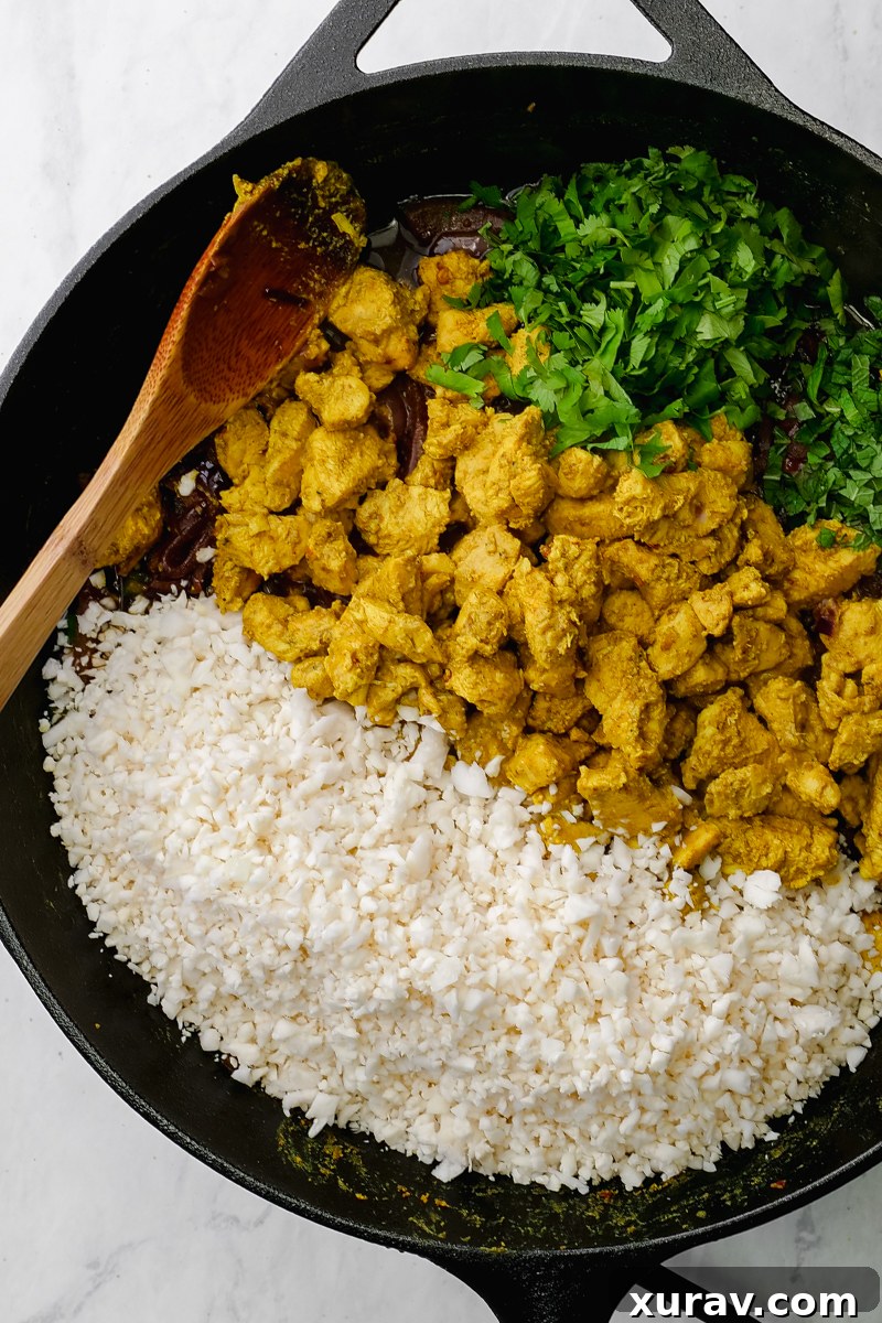 A bowl of freshly cooked Keto Chicken Biryani garnished with fresh mint and cilantro.