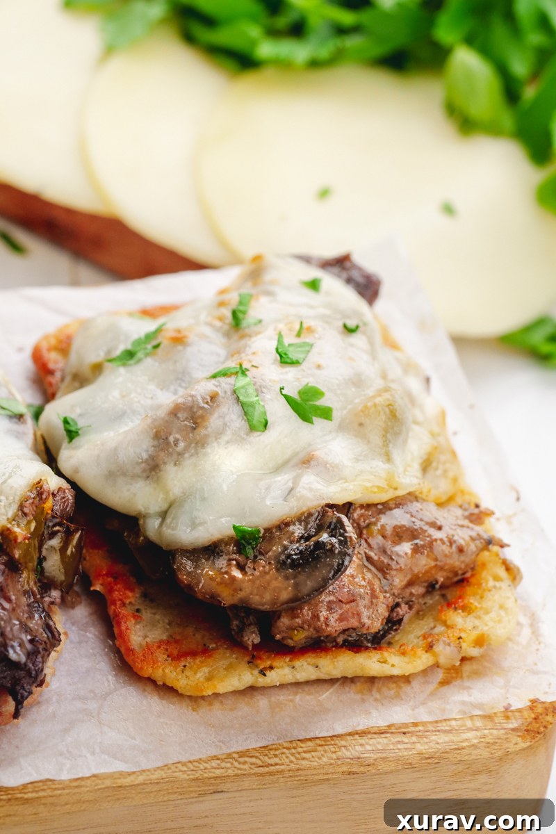 Delicious Crockpot Philly Cheesesteak filling with tender steak, peppers, onions, and mushrooms.
