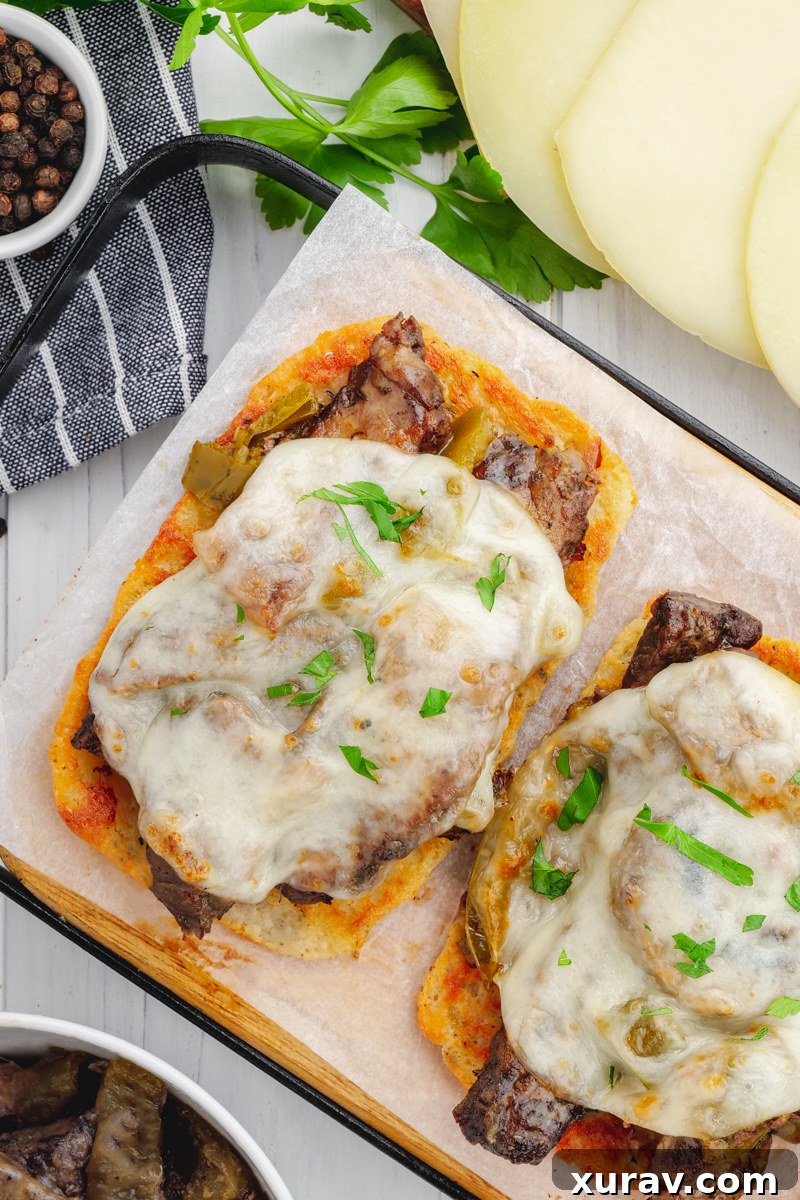 Prep shot of thinly sliced beef sirloin, bell peppers, onions, and mushrooms ready for the crockpot.