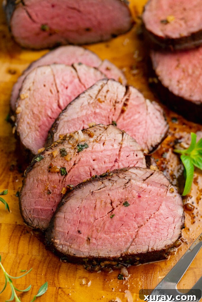 Slices of roast beef tenderloin with a rich herb butter