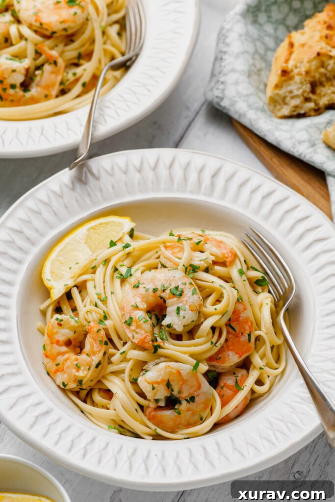 Classic Shrimp Scampi served on a white plate with a fork, ready to be enjoyed.