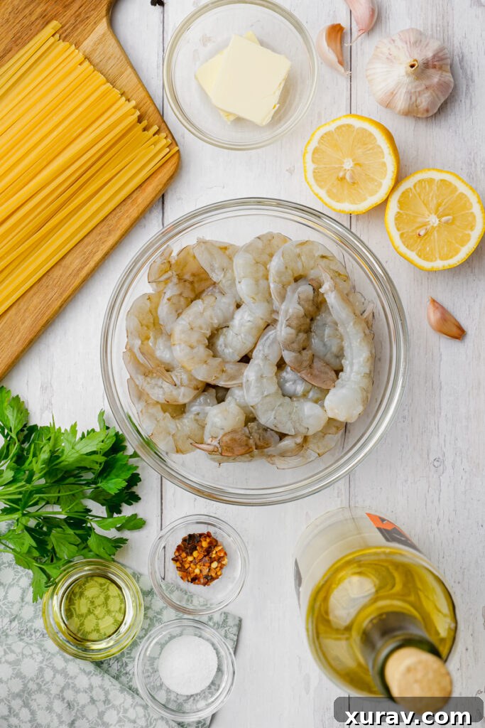 A vibrant collection of fresh ingredients laid out on a wooden board, ready for making shrimp scampi.
