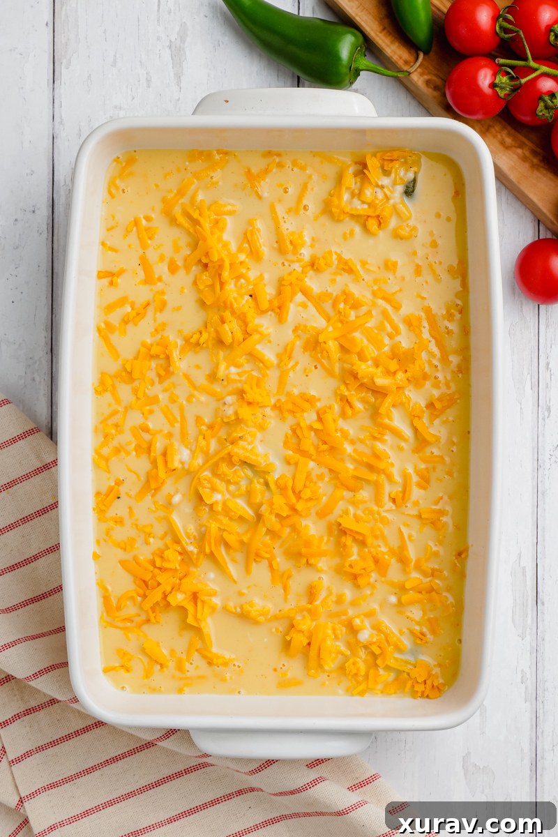 Egg mixture poured on top of chiles rellenos in a baking dish