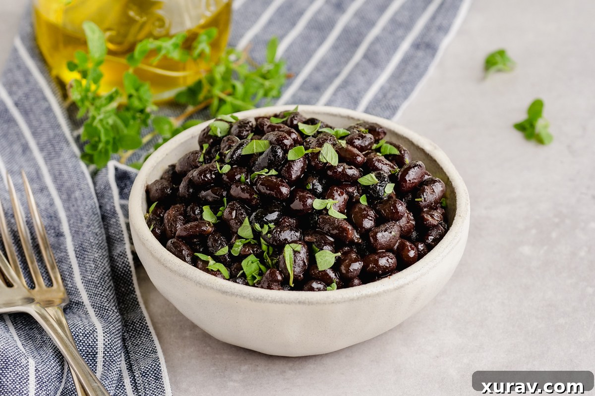 A bowl of black beans from the instant pot with a spoon