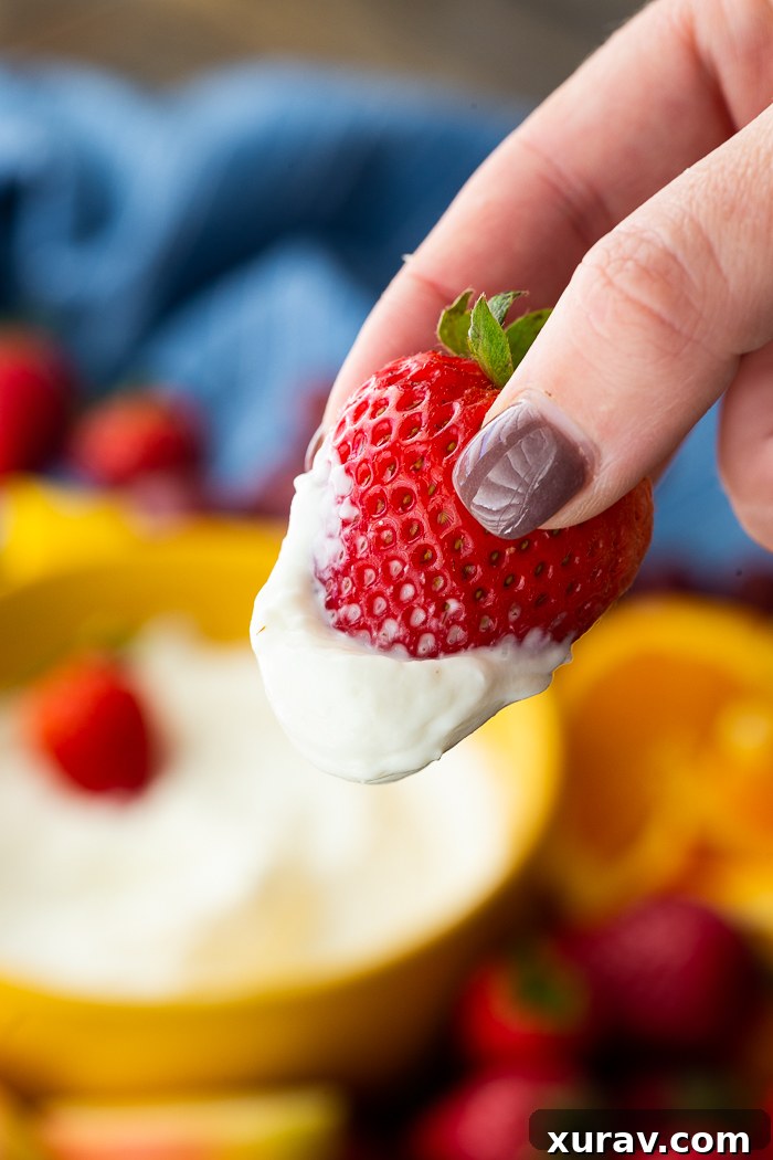 Bowl of fruit dip with various fruits for dipping