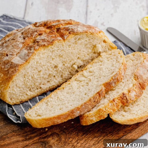 pieces of bread on a wooden cutting board with butter in the background
