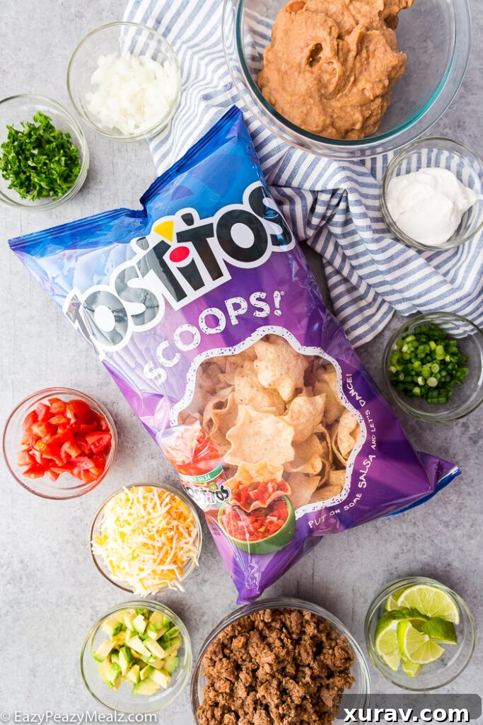 A bag of Tostitos Scoops! and bowls with toppings for taco bites.
